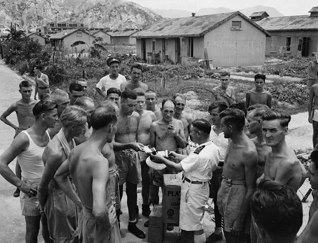 Lieutenant-Commander Fred Day of H.M.C.S. PRINCE ROBERT meeting with liberated Canadian prisoners-of-war at Shamshuipo Camp, Kowloon, Hong Kong, September 1945 Item ID number:3617924