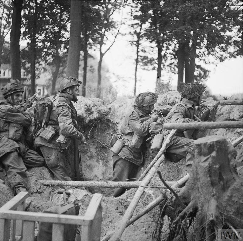 Troops of the 1st Paratroop Battalion take cover in a shell hole in Arnhem, 17 September 1944.