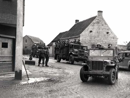 The 7th Brigade is moving through a village in the vicinity of Leopold canal, October 18th, 1944.
