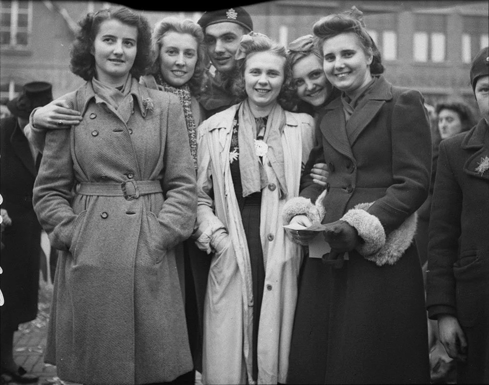 Sgt. W. Anaka, Fort Garry Horse, 2 Canadian Infantry Division, with Dutch girls, celebrating liberation of Beveland area of the Netherlands. Goes, Netherlands, 30 Oct. 1944