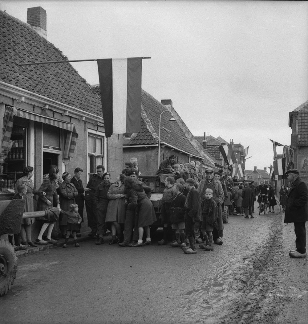 Dutch civilians and members of the 8th Reconnaissance unit, 2 Canadian Infantry Division, during liberation of Beveland province, the Netherlands. Oostkerke, Netherlands, 1 Nov. 1944