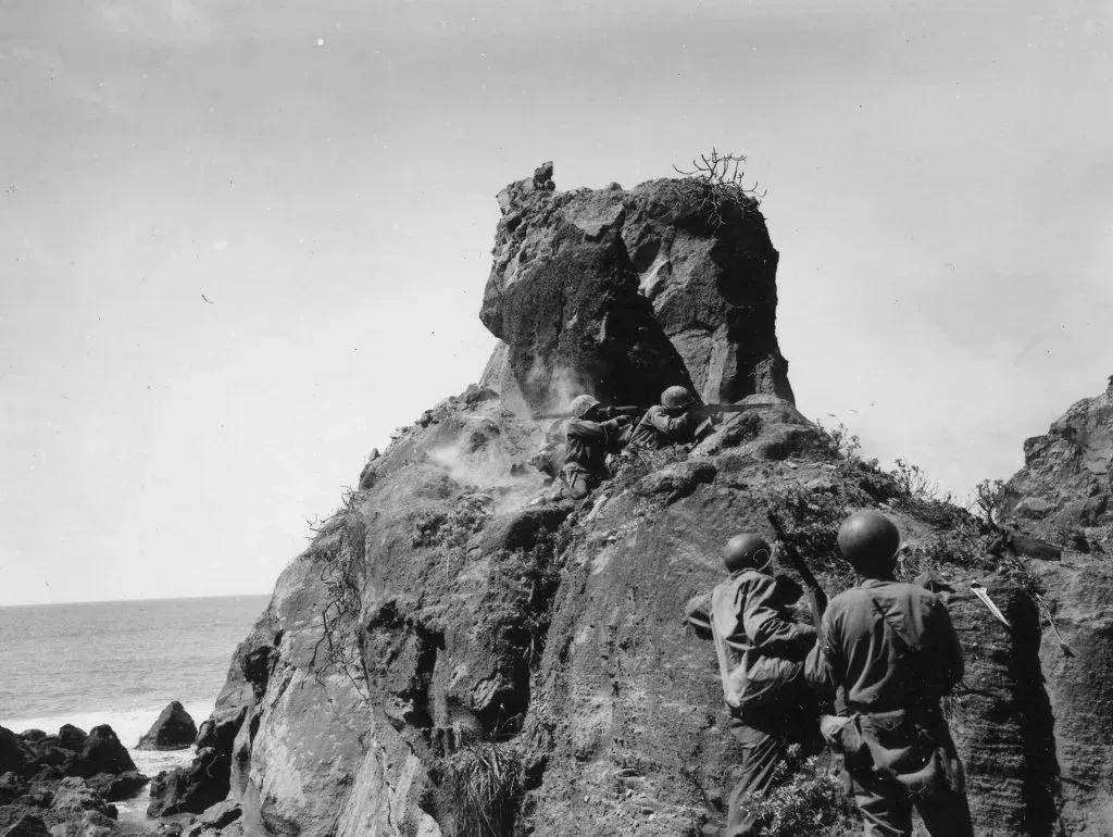 US Army soldiers from the 147th Infantry engaging heavily fortified Japanese positions at Iwo Jima