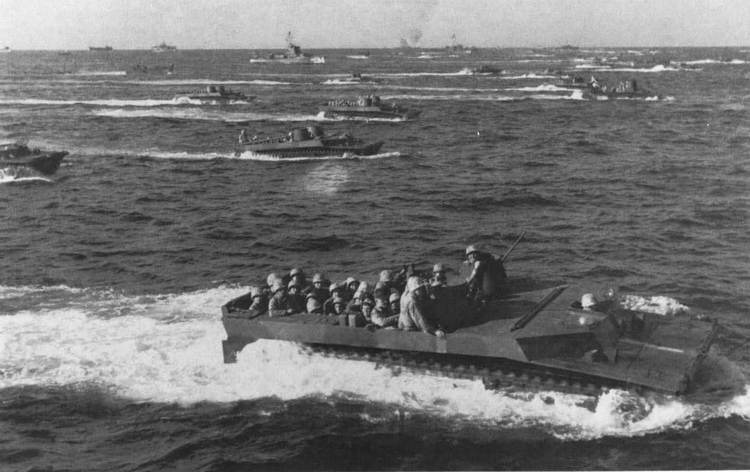 Tracked landing vehicles (LVTs) approach Iwo Jima