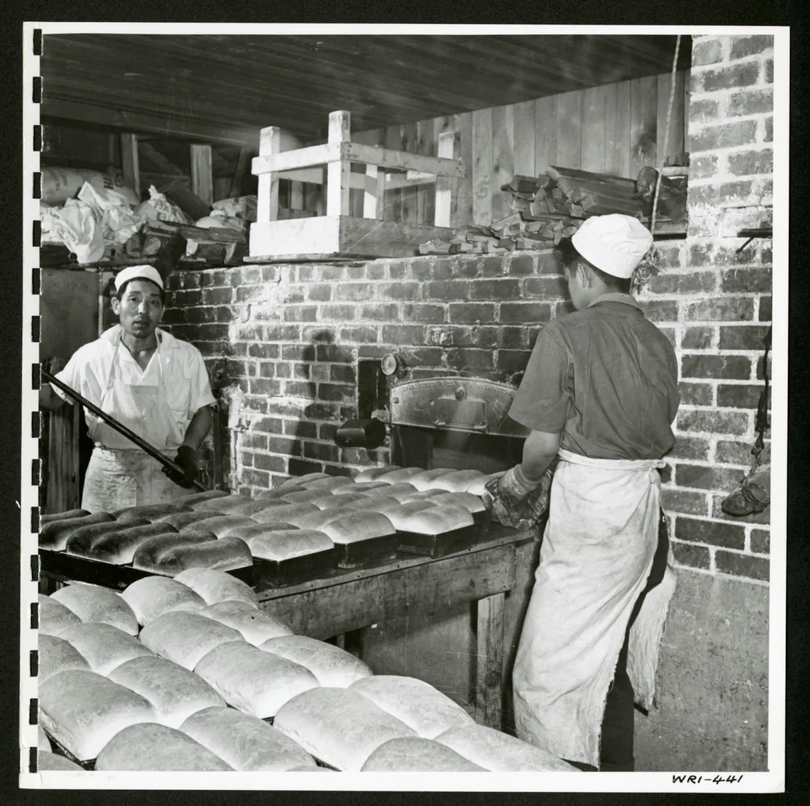 Mass production methods are used in the bakery at Tashme internment camp