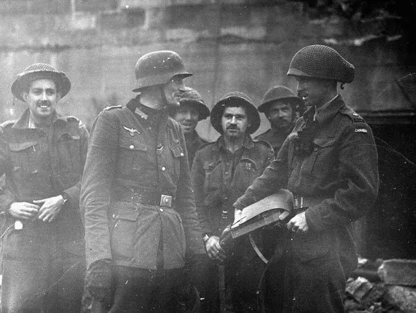 Canadian soldiers with the last German officer at the Mont Lambert fortification, Boulogne, France, 17 September 1944