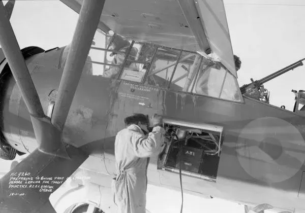An unidentified pilot preparing for a gunnery practice flight in a Westland Lysander II aircraft of No. 110(AC) Squadron, RCAF, Rockcliffe, Ontario, 18 January 1940