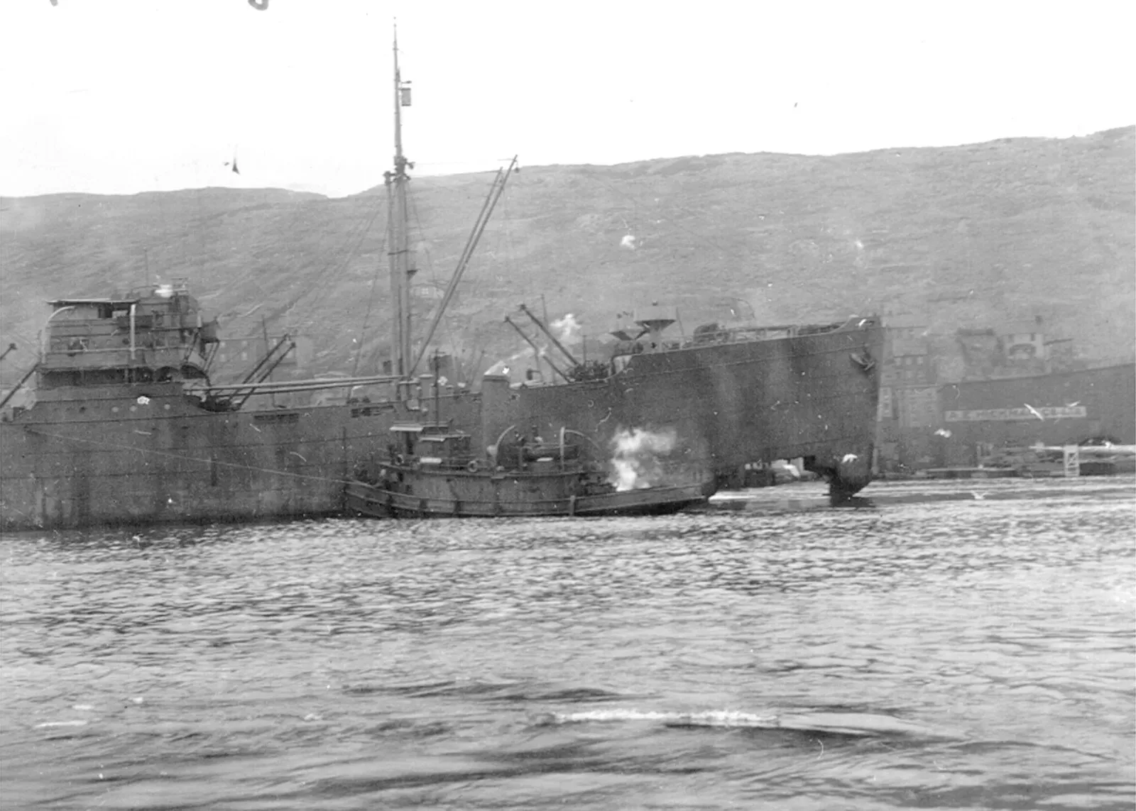 The Dutch freighter SS Moderita, torpedoed by a German U-boat, with a large hole in the bow, makes for St. John's, NF, March 1944