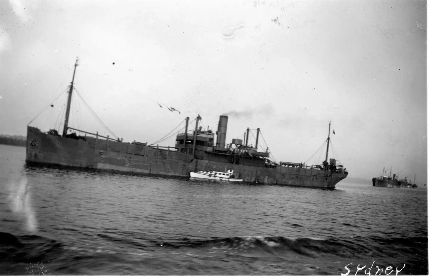 RCN examination vessel inspecting merchant ships arriving from a convoy at Sydney, NS, 1942