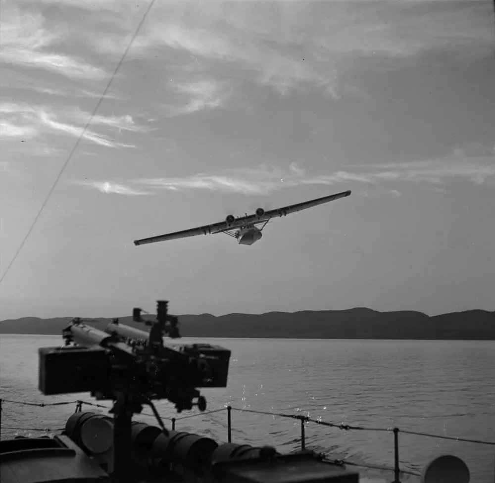 Consolidated Catalina or Canso flying over a Fairmile on exercise at Gaspé, June 1943