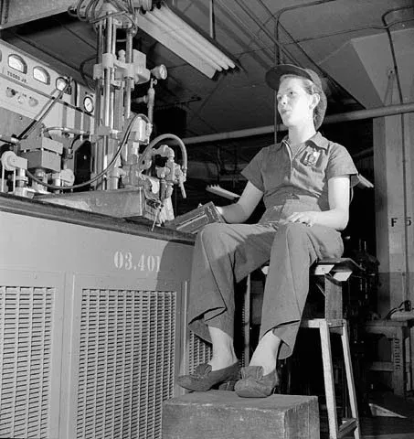 Female factory worker whistles as piped music plays in a factory
