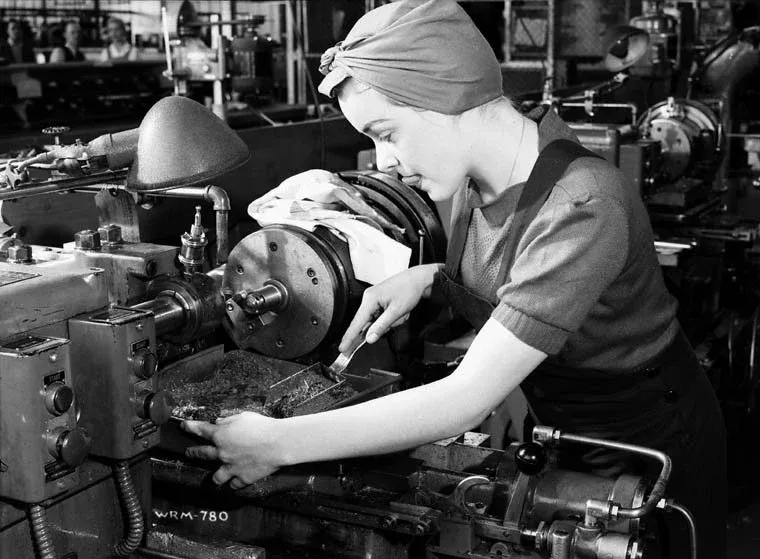 Veronica Foster, known as 'the girl with the machine gun', at a lathe on the Bren machine gun production line at John Inglis Co. Ltd.