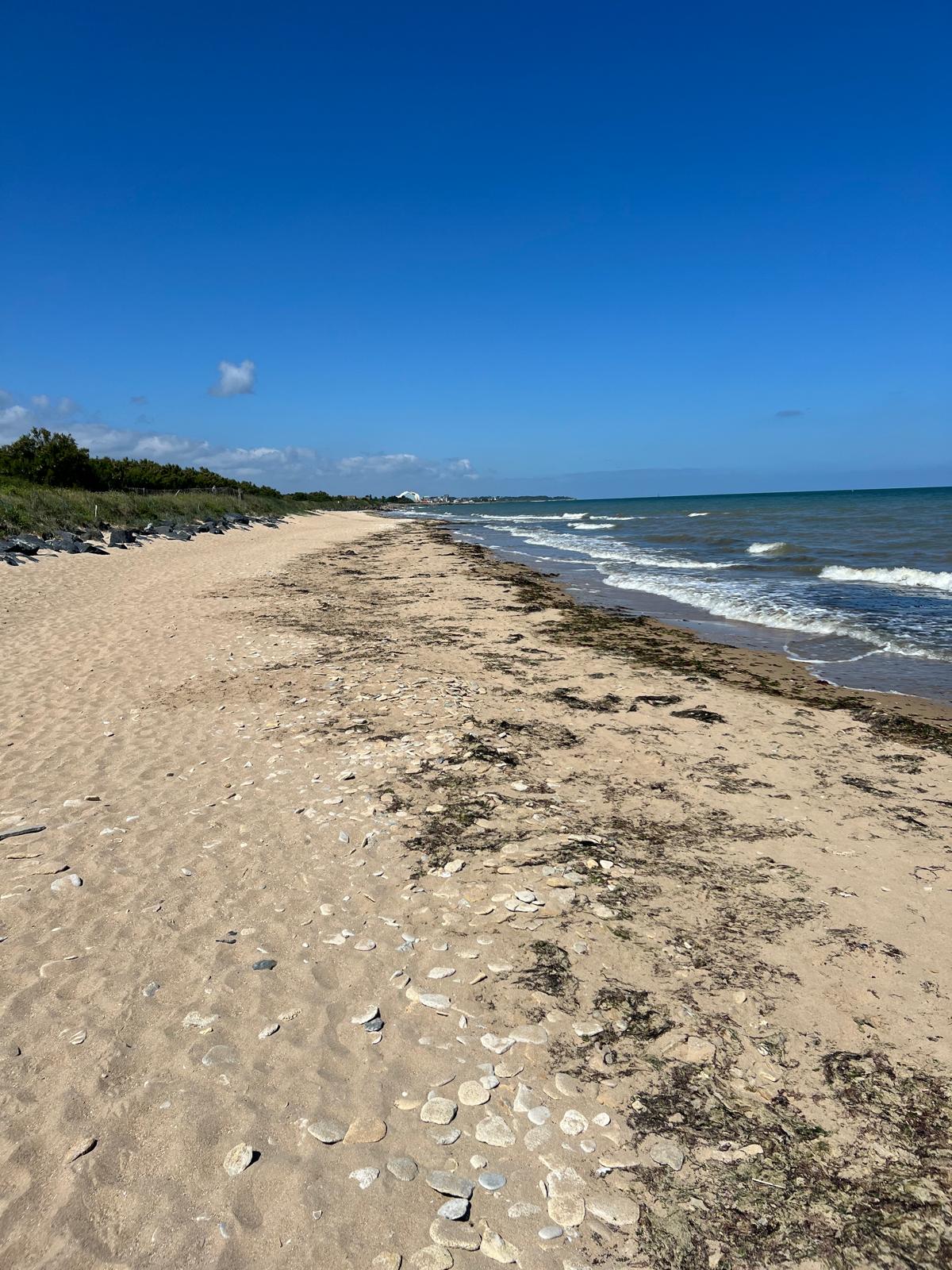 The Normandy coastline at Juno sector. Troops and vehicles move inland through the gap in the seawall.